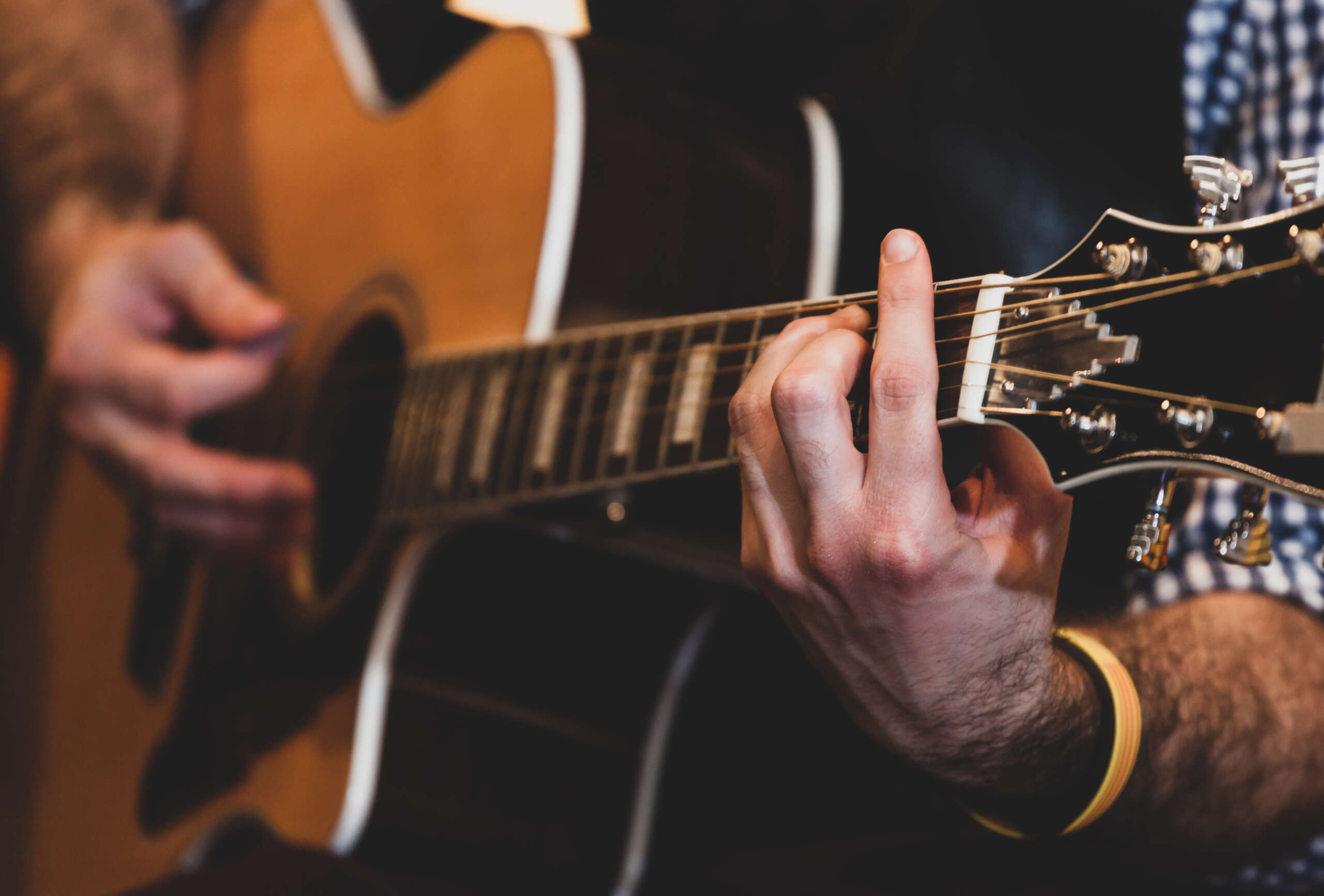 Playing classic guitar. Selective focus.