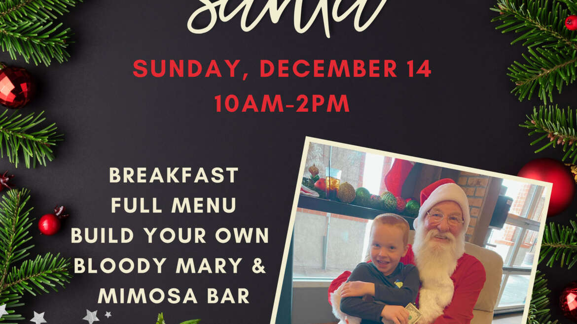 Child smiling sitting on Santa's lap for Breakfast with Santa at BLVD Tavern